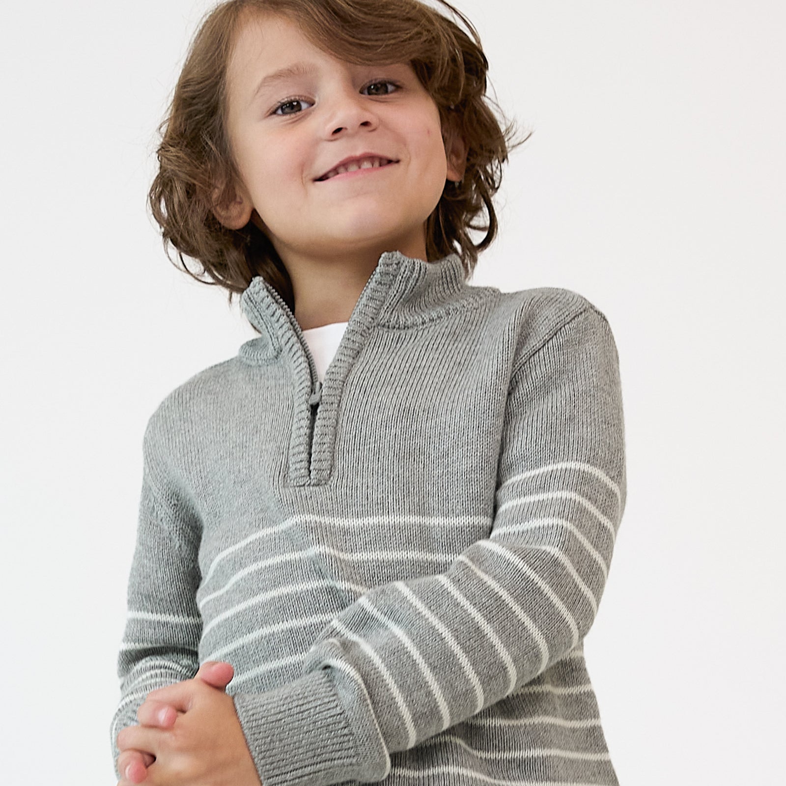 Close up image of a child wearing a Heather Gray Stripes Zip Sweater