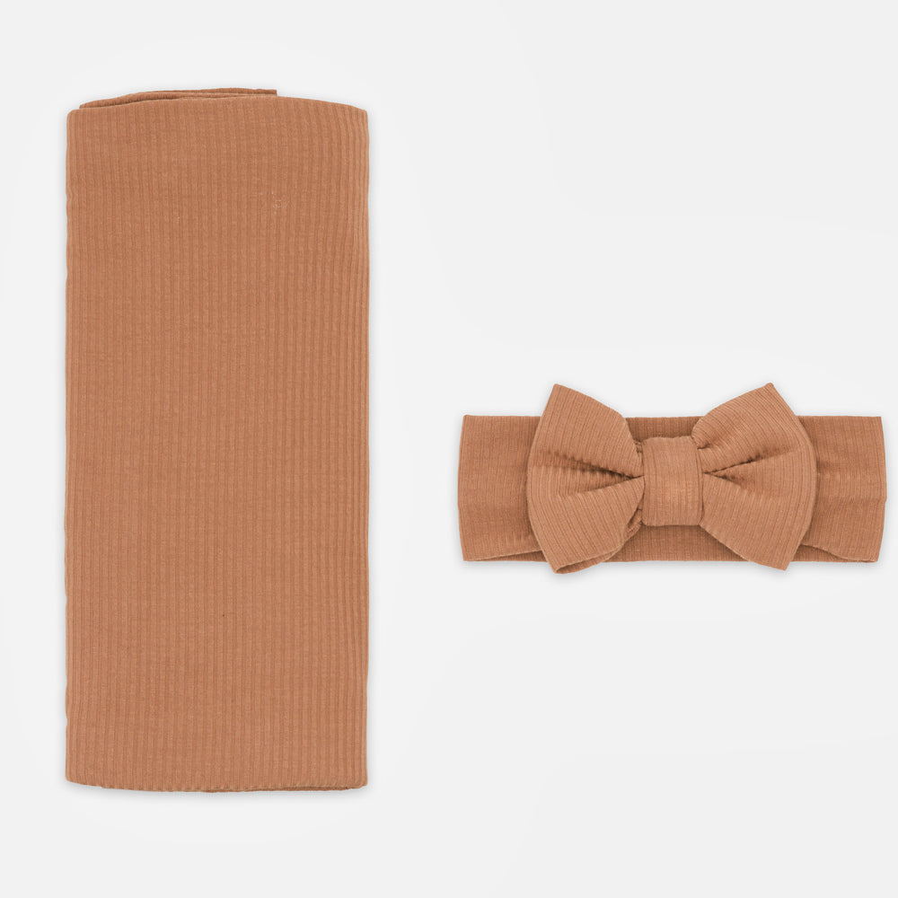 Flat lay image of the Caramel Ribbed Swaddle & Luxe Bow Headband Set