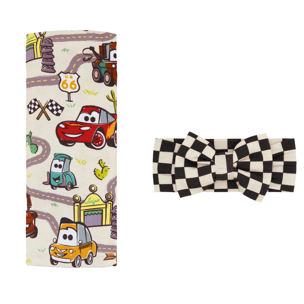 Flat lay image of a Radiator Springs swaddle and luxe bow set