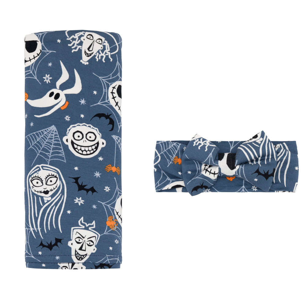 Flat lay image of the Disney Jack & Crew Swaddle & Luxe Bow Headband Set