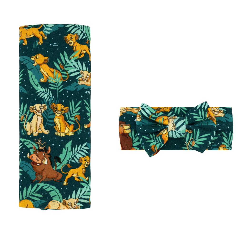 Flat lay image of a Disney Simba's Sky swaddle and luxe bow headband set