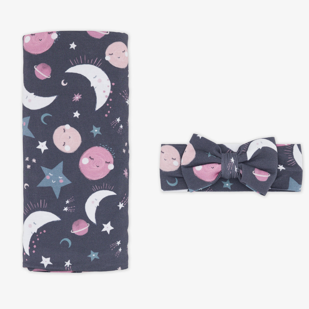 Flat lay image of a Pink to the Moon and Back swaddle and luxe bow headband