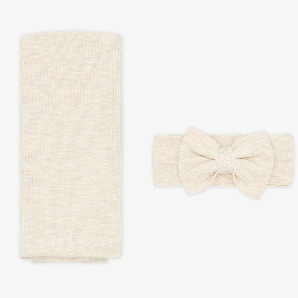 Flat lay image of a Heather Oatmeal Ribbed Swaddle and Luxe Bow Headband Set