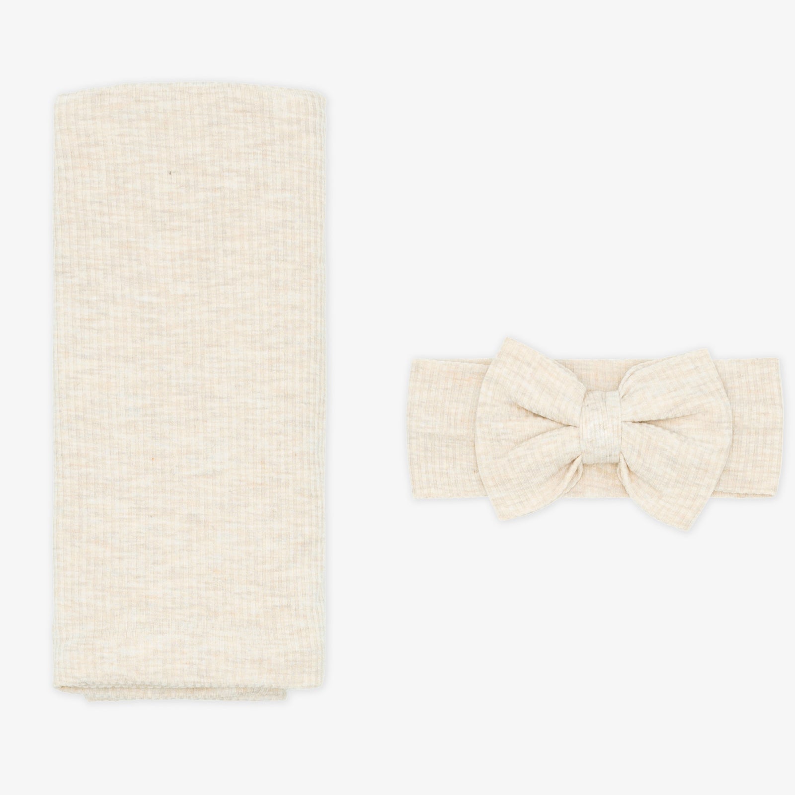 Flat lay image of a Heather Oatmeal Ribbed Swaddle and Luxe Bow Headband Set