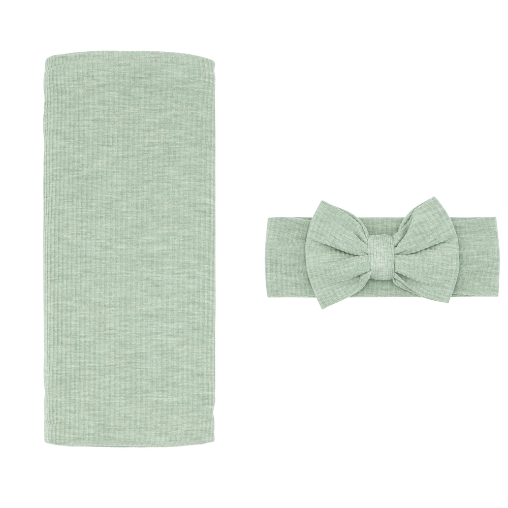 Click to see full screen - Flat lay image of a Heather Sage swaddle and Luxe bow Headband Set
