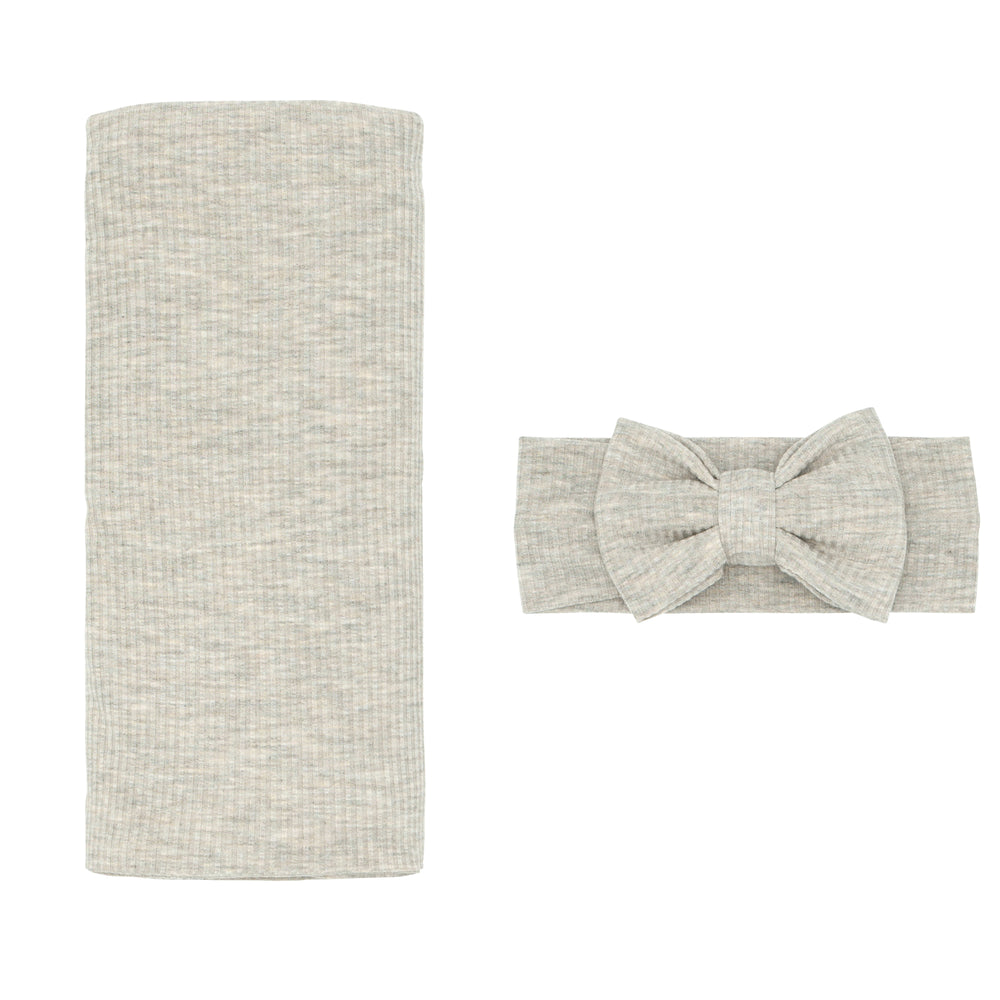 Flat lay image of a Heather Stone Ribbed swaddle and Luxe bow Headband Set