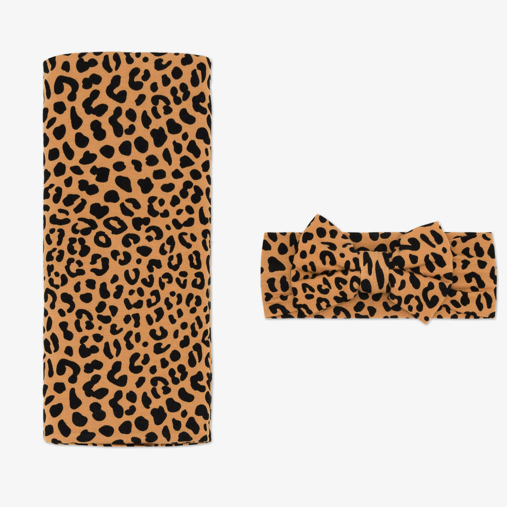 Flat lay image of the Classic Leopard Swaddle & Luxe Bow Headband Set