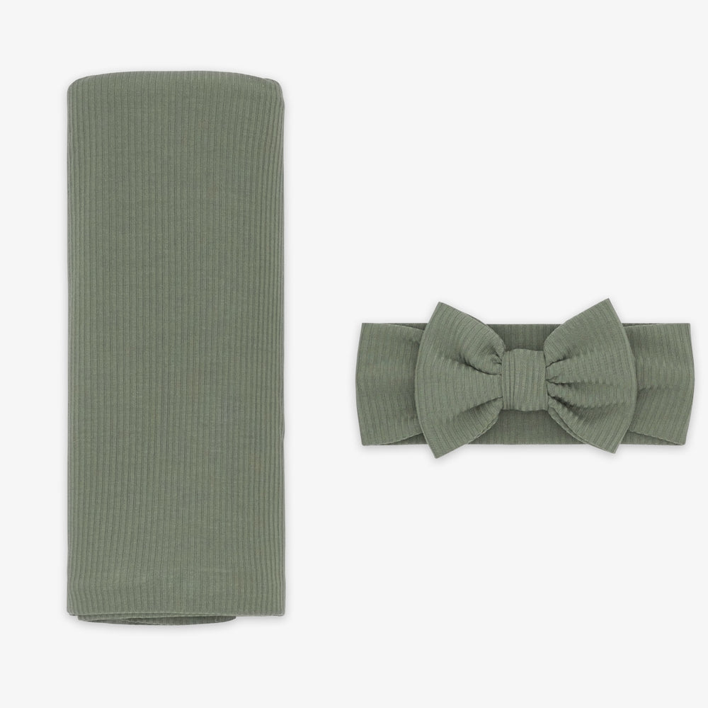 Flat lay image of the Moss Ribbed Swaddle & Luxe Bow Headband Set