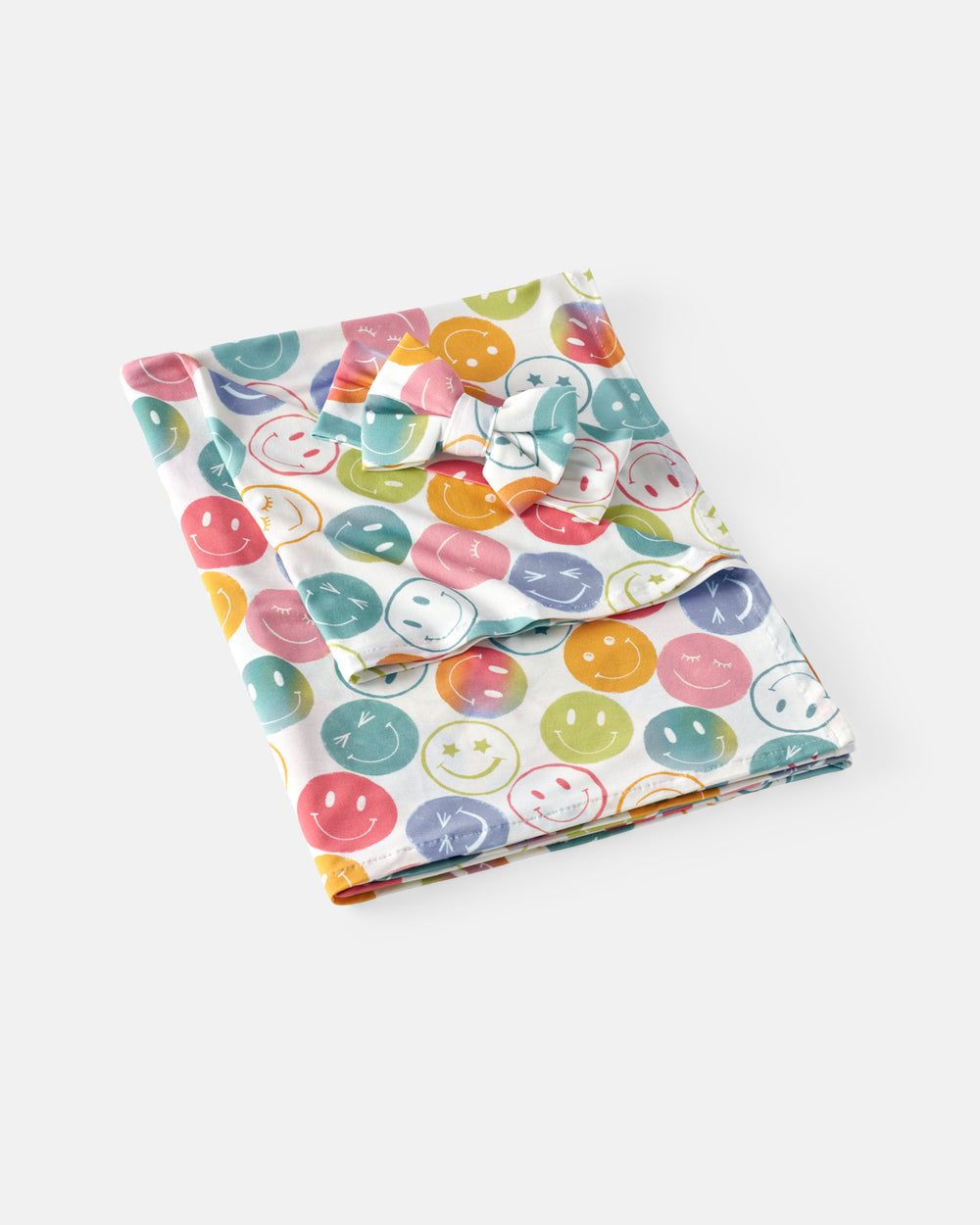 Flat lay of the Positive Vibes Swaddle & Luxe Bow Headband Set