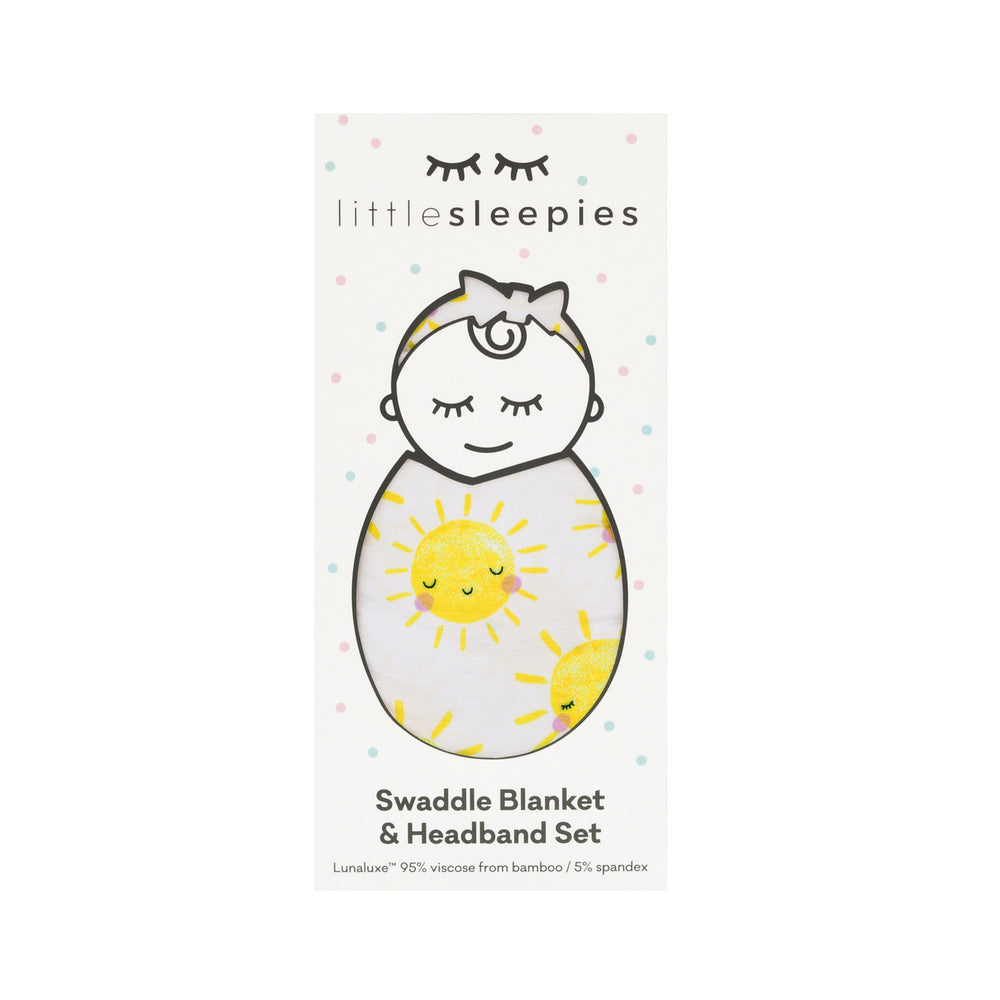 Flat lay image of a Sunshine Swaddle and Luxe Bow Headband Set in Little Sleepies peek a boo packaing