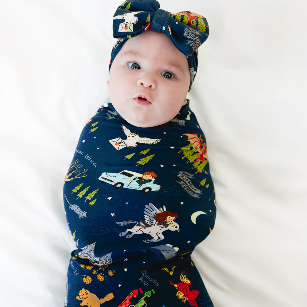 Alternate image of a child swaddled in an Evening at Hogwarts swaddle and luxe bow headband set