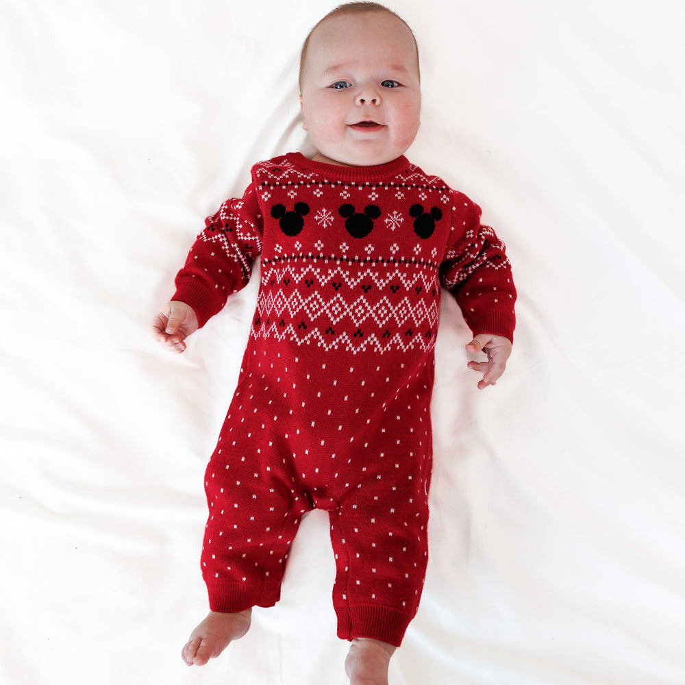 Image of an infant laying on a blanket wearing a Vintage Mickey Fair Isle Sweater Romper