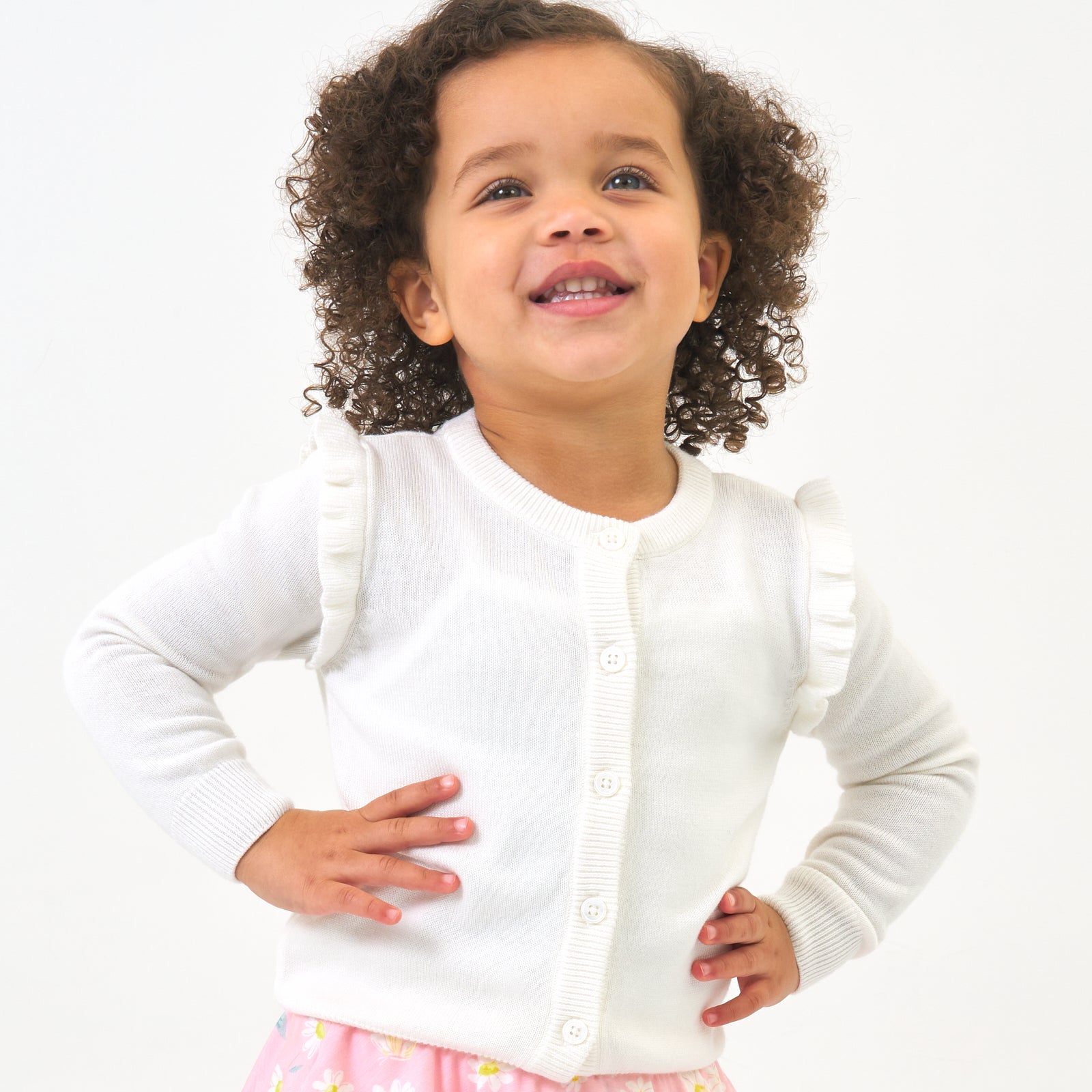 Child wearing an Ivory ruffle cardigan
