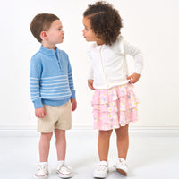 kids looking at eachother in spring clothes