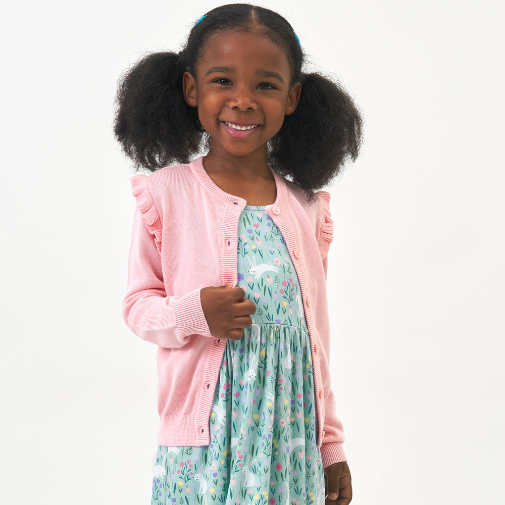Click to see full screen - Child wearing a Pink Blossom ruffle cardigan and coordinating dress
