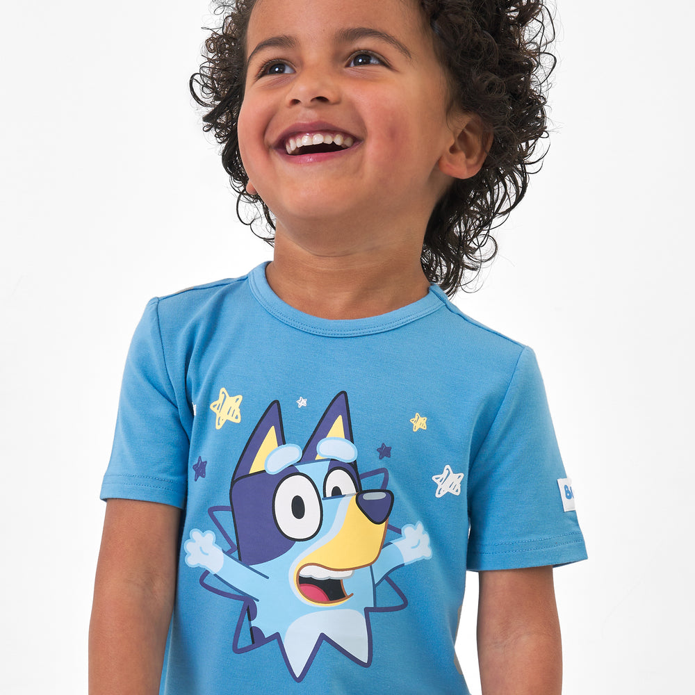 Close up image of a child wearing a Bluey graphic tee