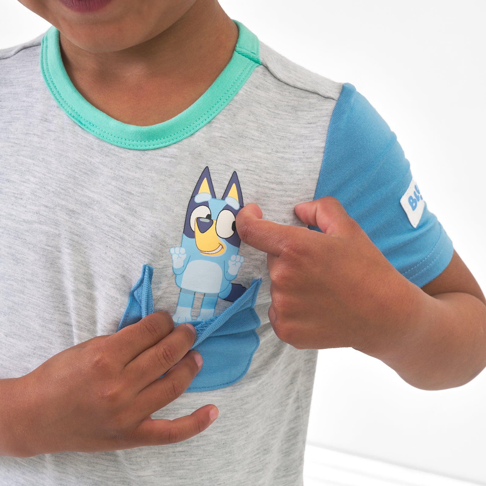 Close up image of a child wearing a Bluey graphic pocket tee
