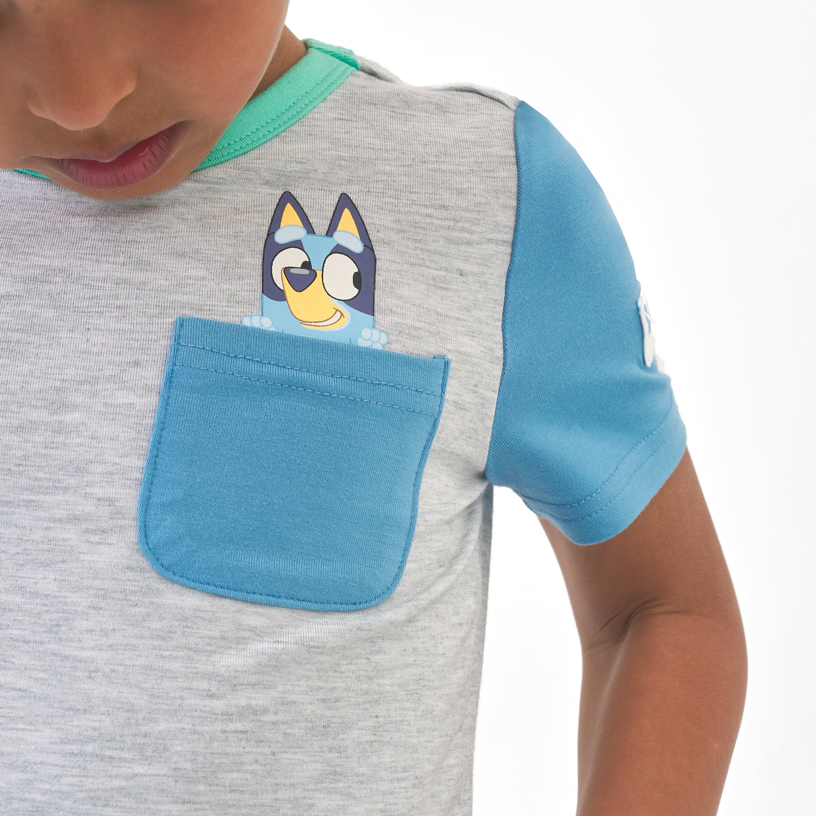 Close up image of the pocket detail while a child is wearing a Bluey graphic pocket tee