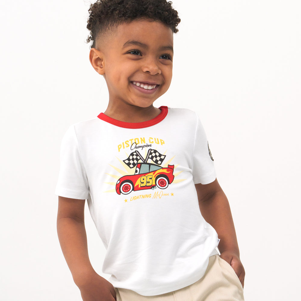 Child wearing a Lightning McQueen graphic tee and coordinating Play shorts