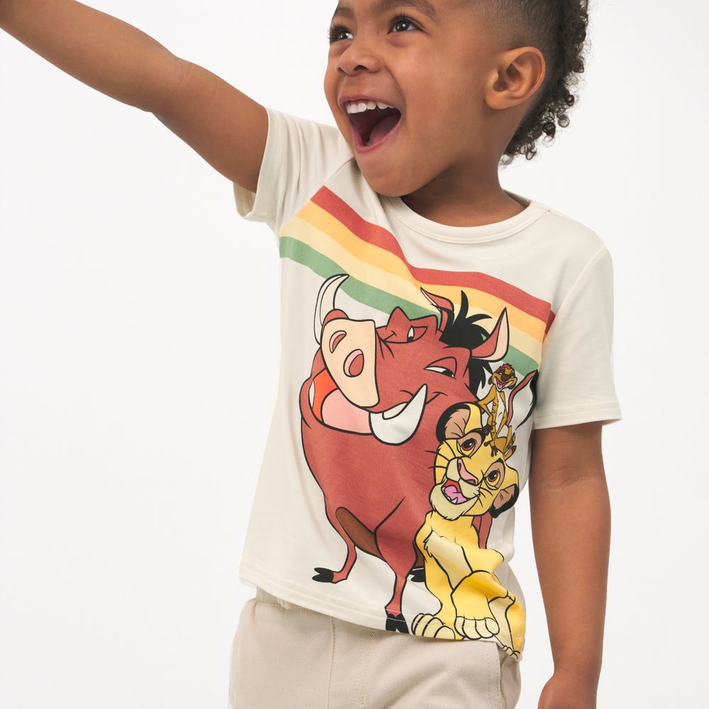 Close up image of a child wearing a Lion King graphic tee and coordinating Play shorts