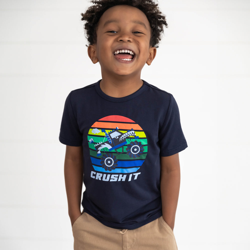 Boy smiling while wearing the Monster Truck Madness Graphic Tee