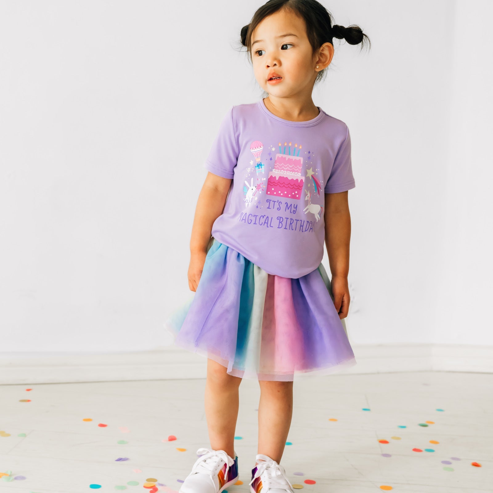 Child wearing a Magical Birthday Light Lavender graphic tee paired with a rainbow tutu skirt