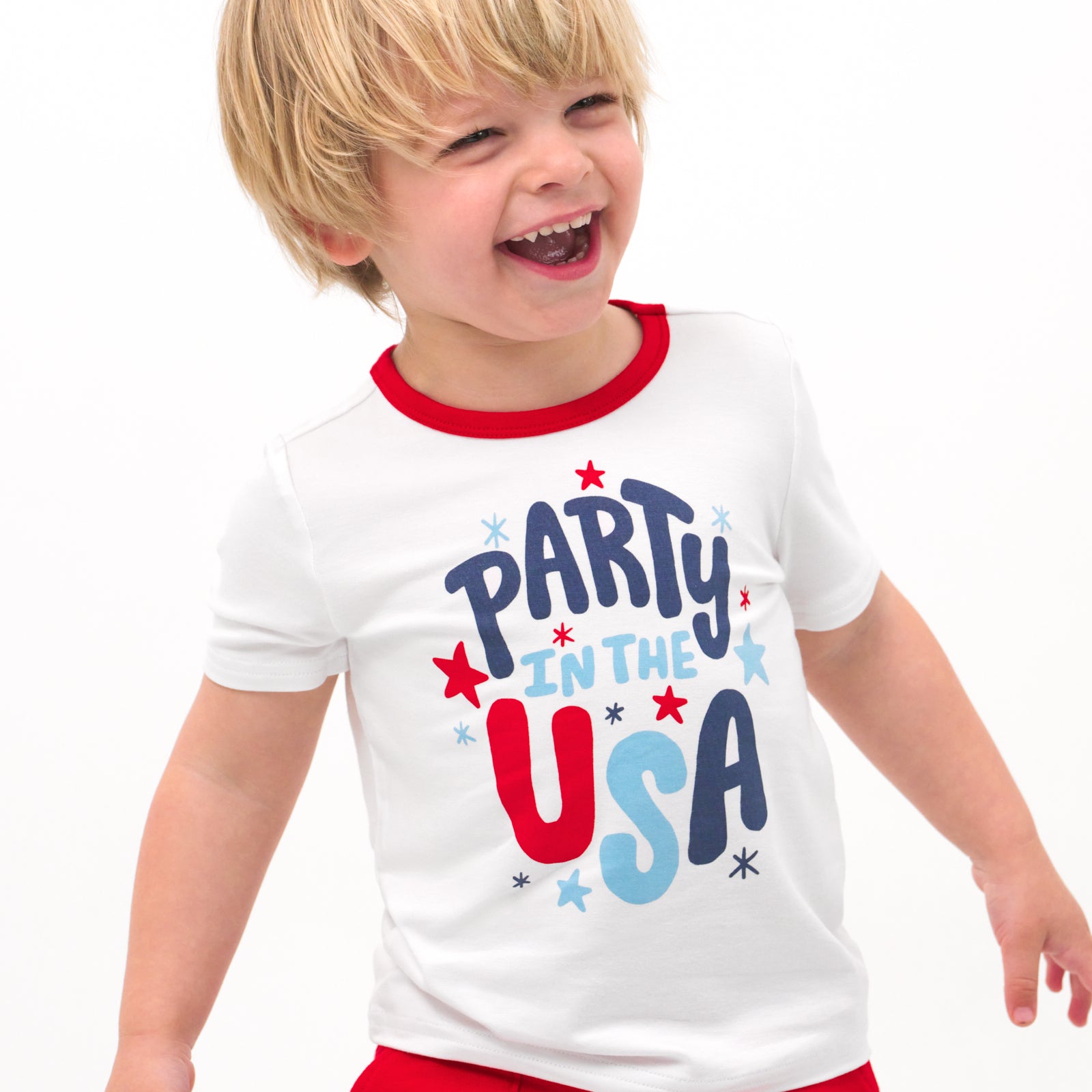 Close up image of a child wearing a Party in the USA graphic tee
