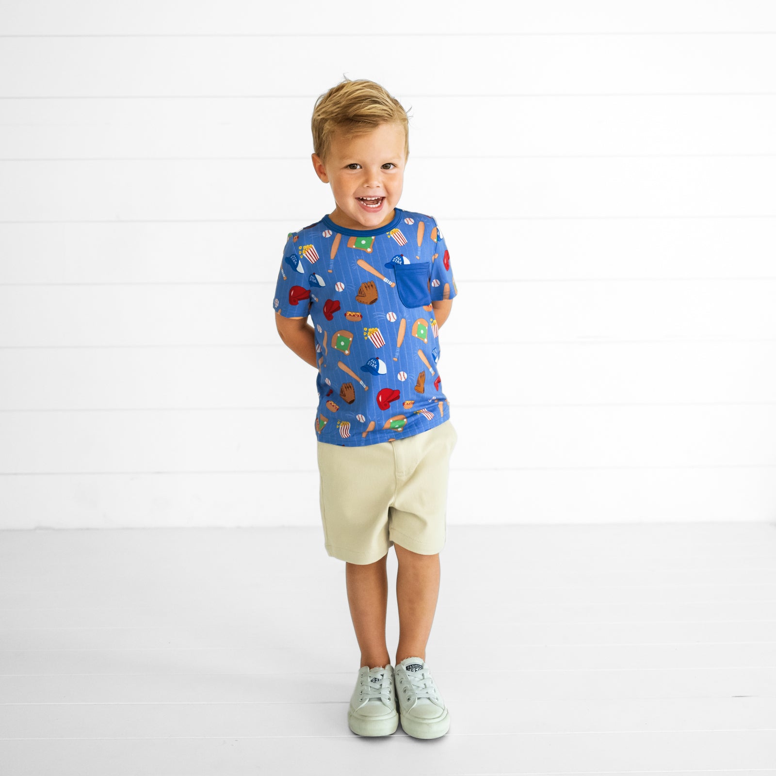 Child wearing a Blue All Stars Pocket Tee and Light Khaki Chino Shorts