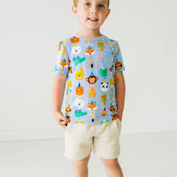 Child wearing Blue Party Pals pocket tee paired with Bone shorts