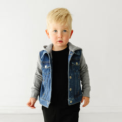 Close up image of a child wearing a Midwash Blue Denim jacket and coordinating Play outfit