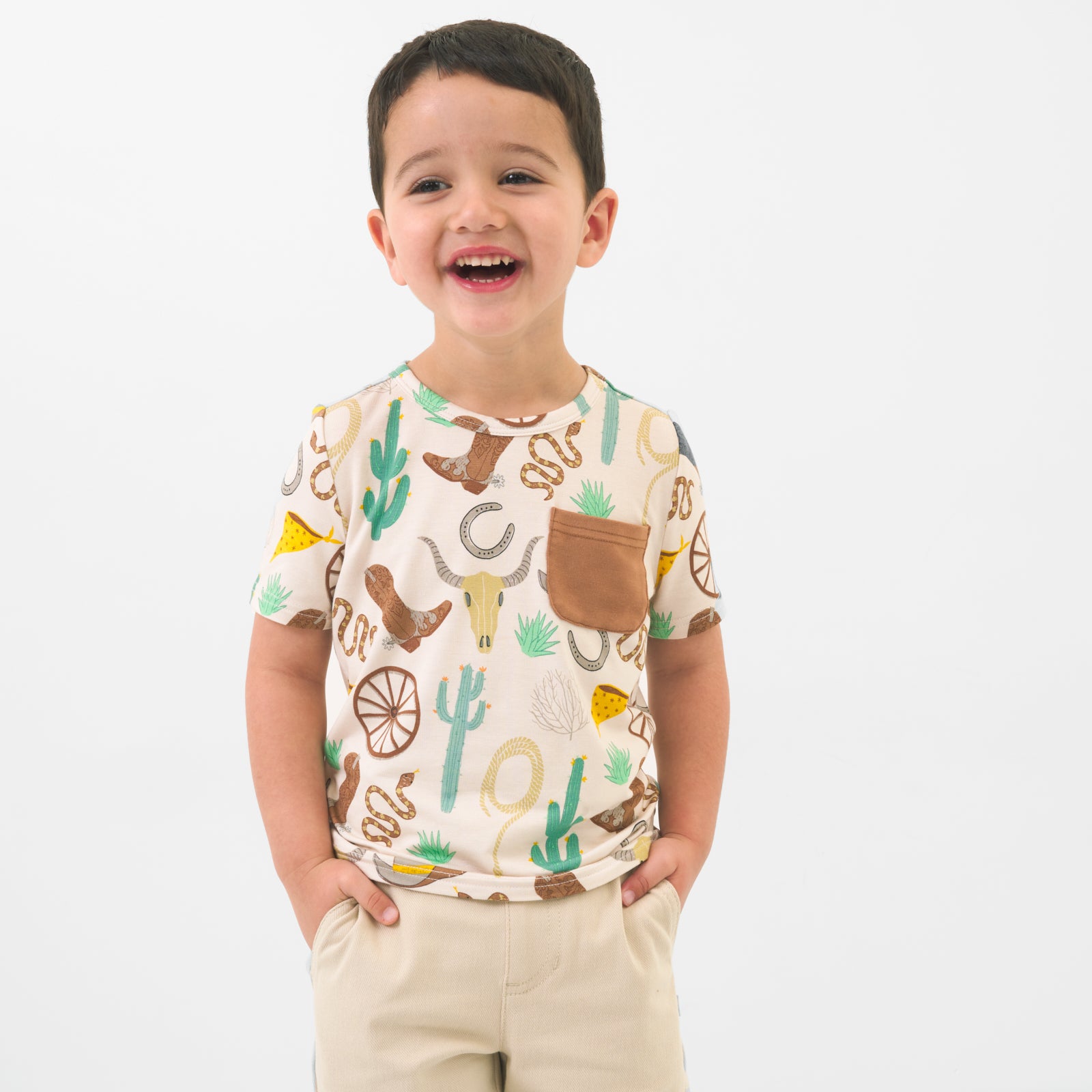 Child wearing a Caramel Ready to Rodeo pocket tee paired with light khaki chino shorts
