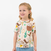 Child wearing a Caramel Ready to Rodeo pocket tee 