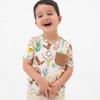Alternate image of a child wearing a Caramel Ready to Rodeo pocket tee 