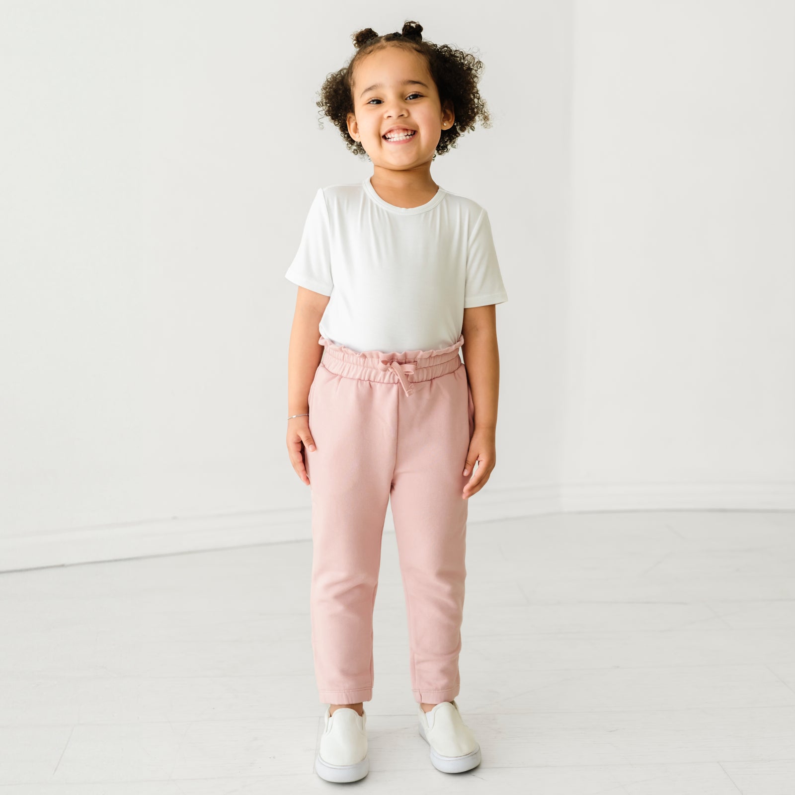 Child wearing Mauve Blush paperbag joggers and coordinating Play top