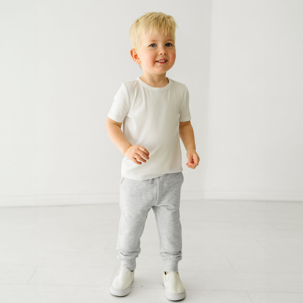 Boy wearing white tee shirt and grey joggers