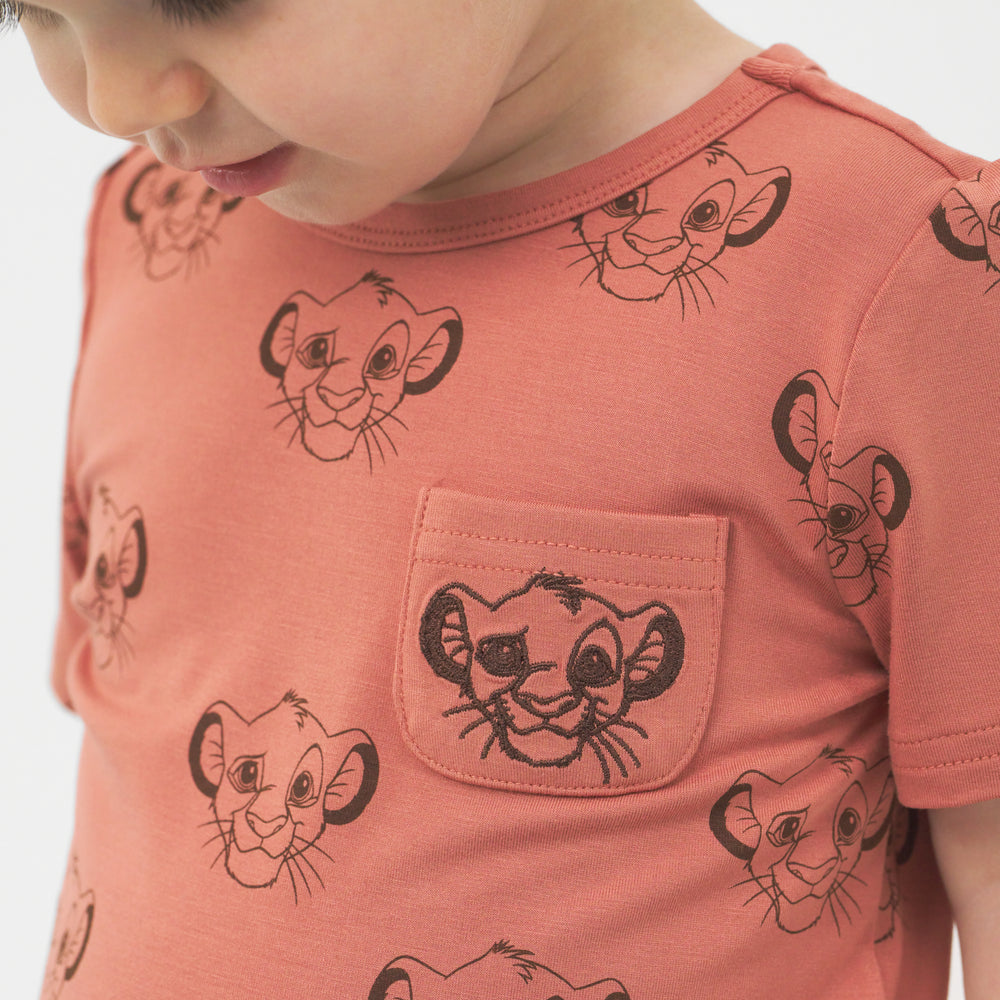 Close up image of a child wearing a Sweet Simba embroidered pocket tee
