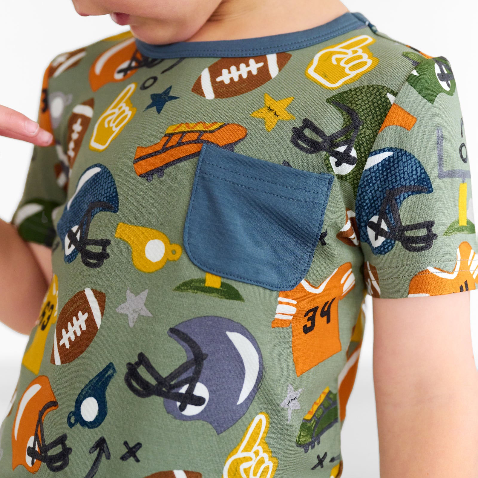 Close up image of a child wearing a Touchdown Time Pocket Tee, detailing the pocket