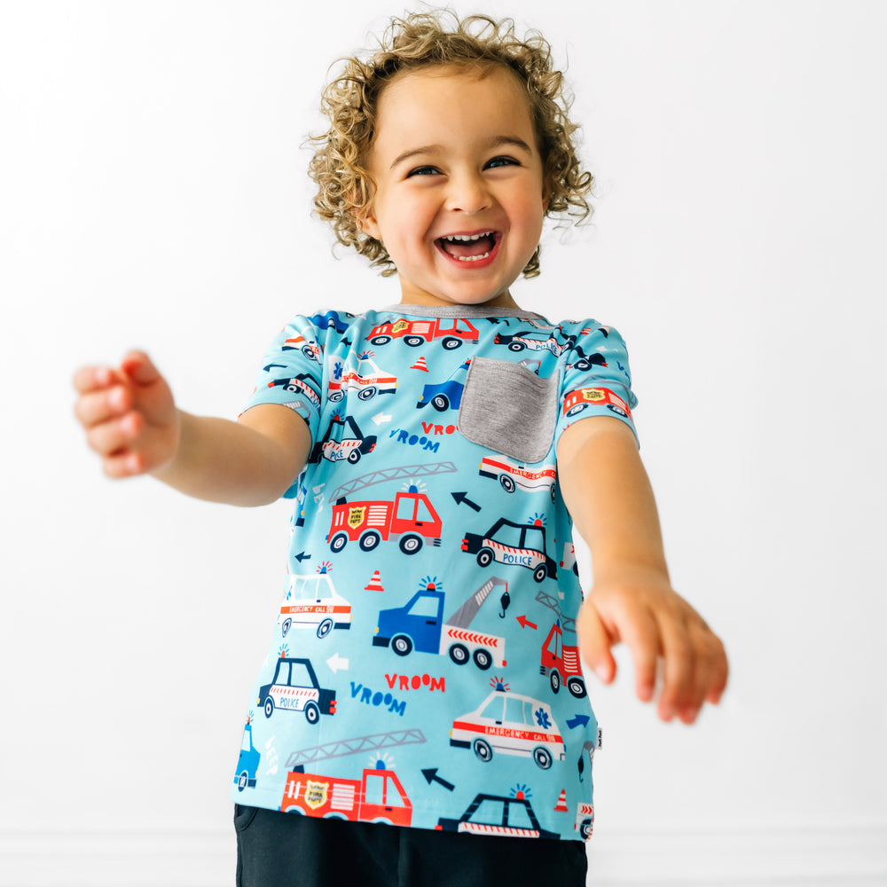 Child playing wearing a To The Rescue pocket tee