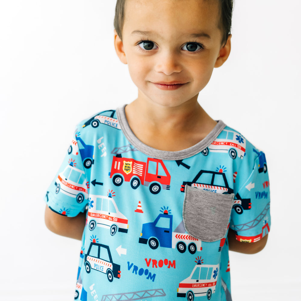 Close up image of a child wearing a To The Rescue pocket tee