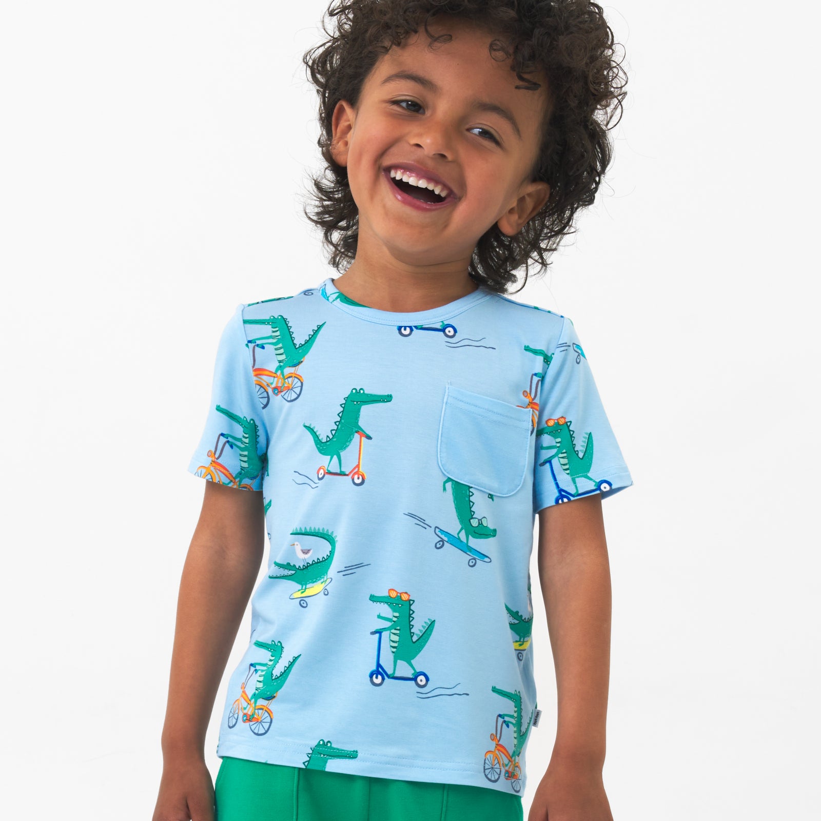 Close up image of a child wearing a Later Gator pocket tee and coordinating shorts