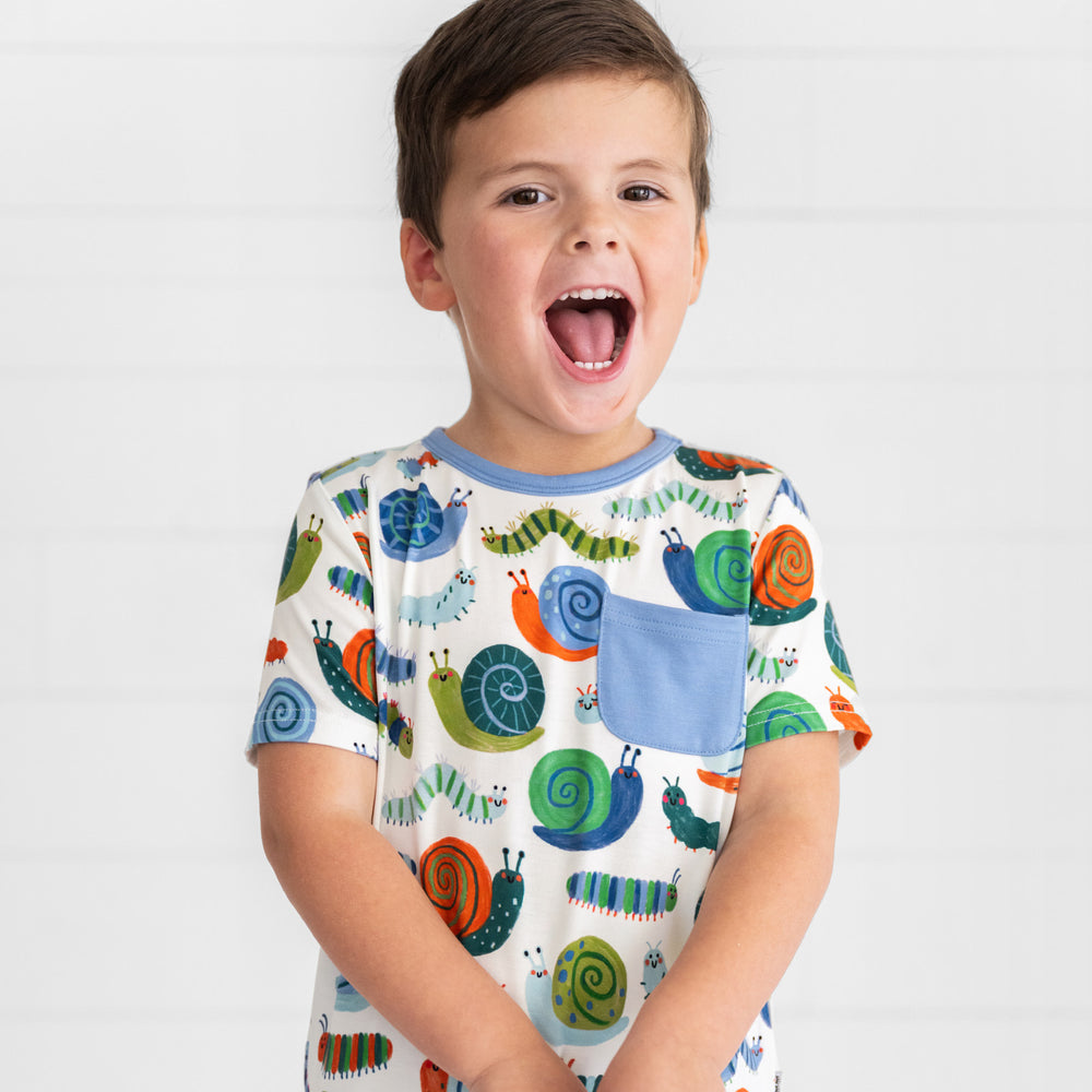 Close up image of boy wearing the Inchin' Along Pocket Tee