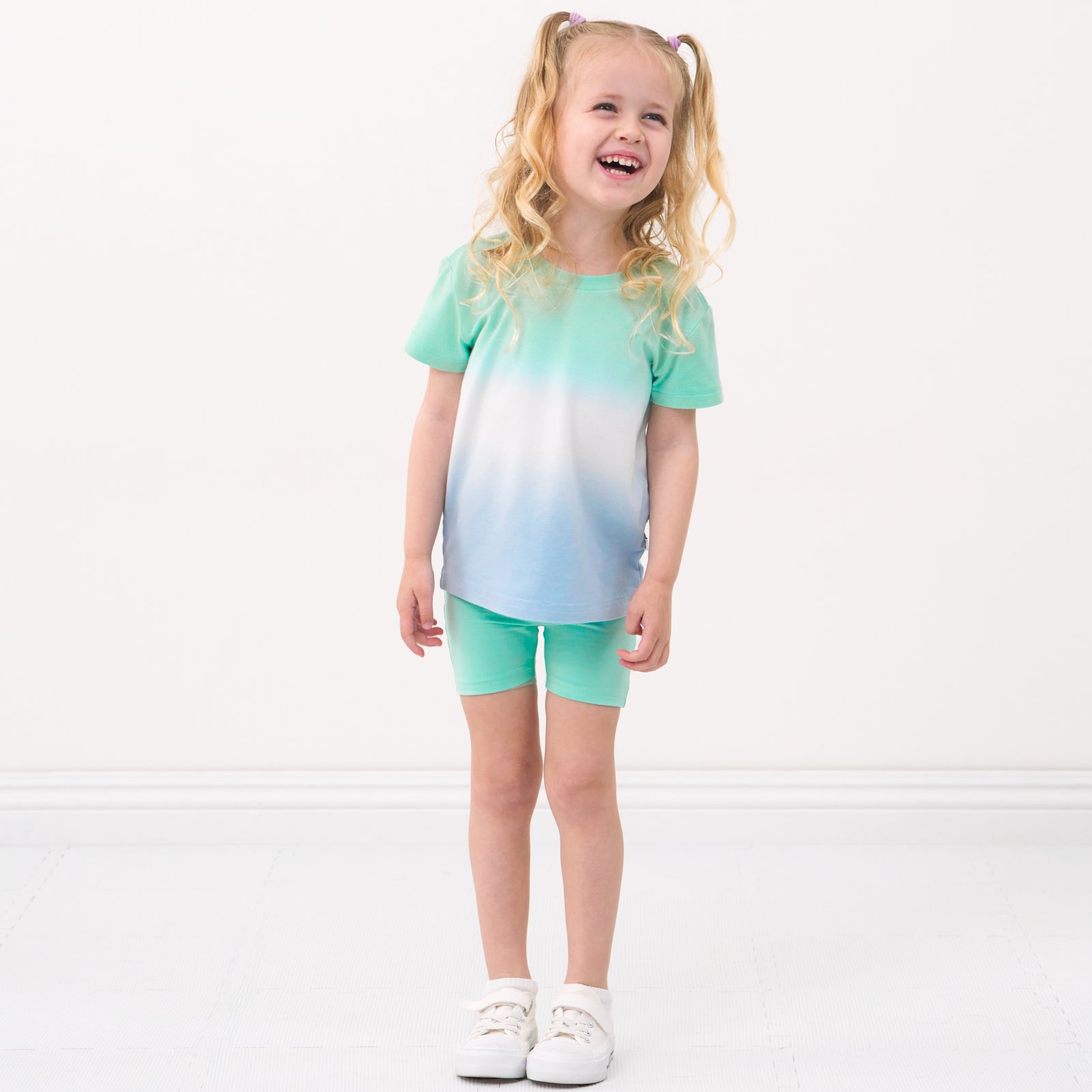 Child wearing a Cool Ombre relaxed tee and coordinating bike shorts