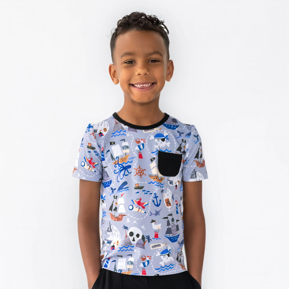 Boy smiling while wearing the Pirate's Map Pocket Tee