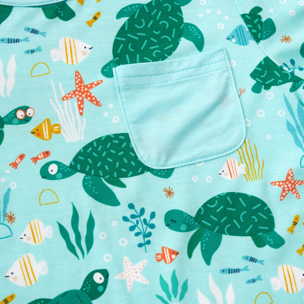 Close up detail shot of a Sea Turtle Friends Pocket Tee