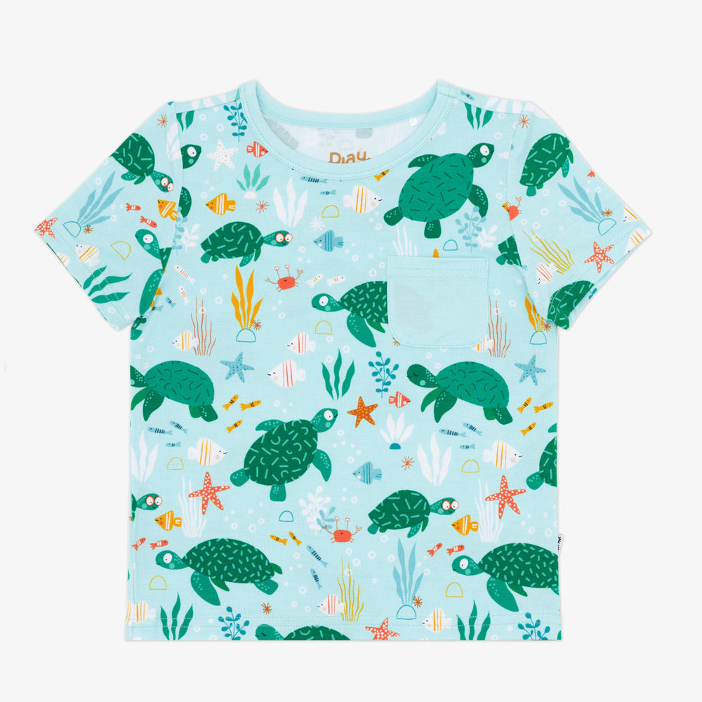 Flat lay image of a Sea Turtle Friends Pocket Tee