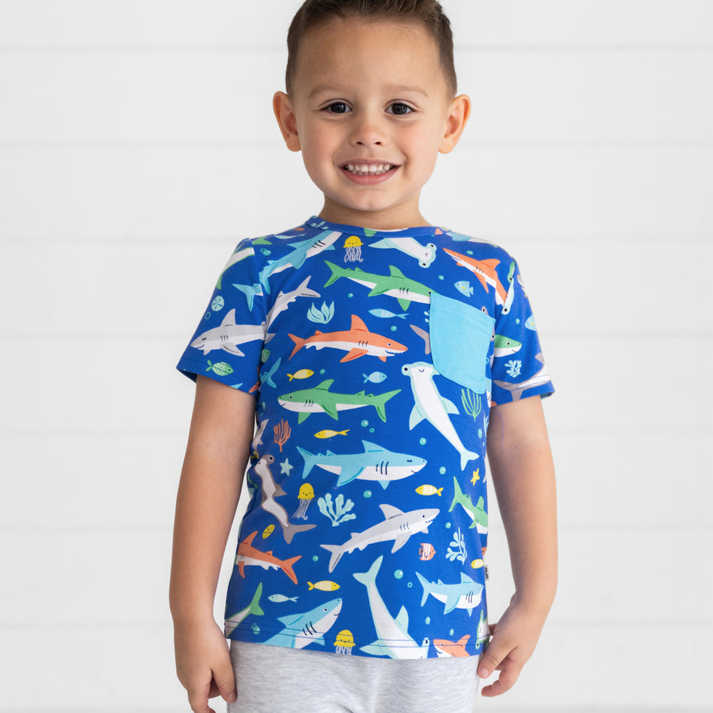 Smiling boy wearing the Rad Reef Pocket Tee