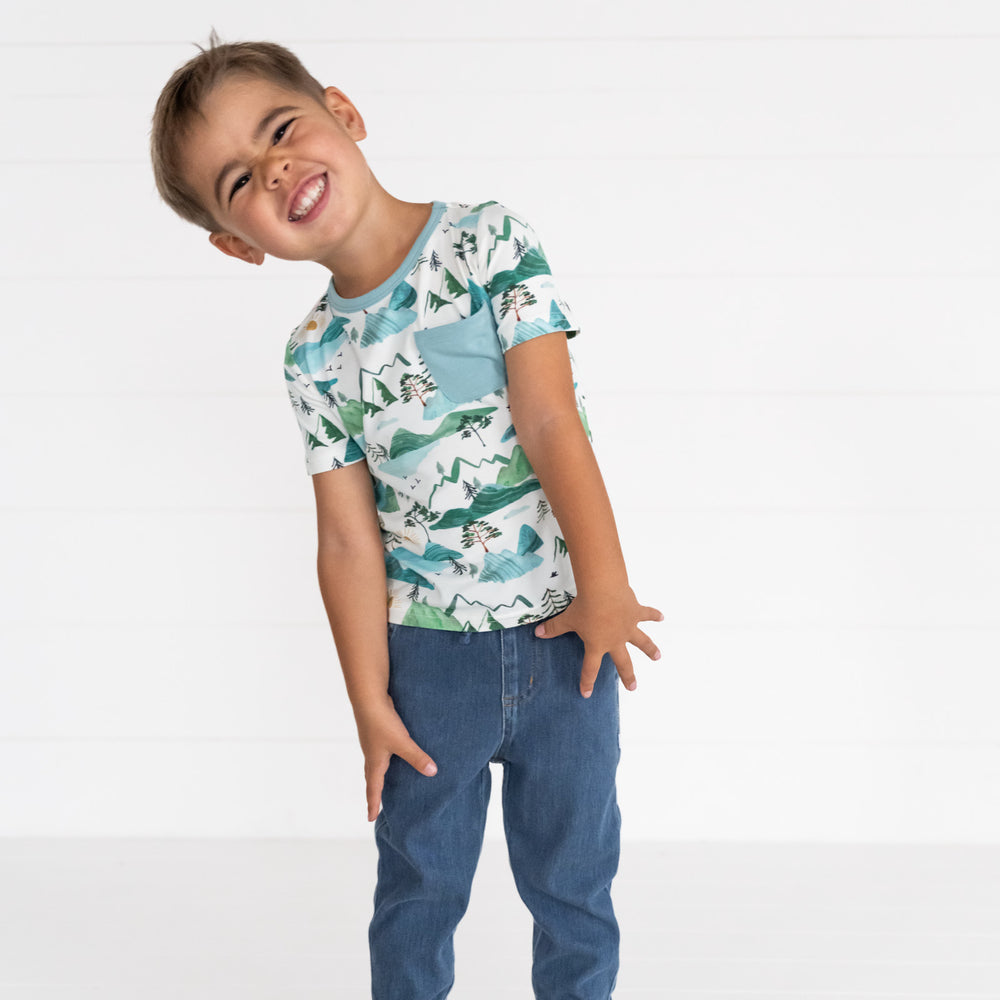 Image of a child wearing a Mountain Mist Pocket Tee and Midwash Blue Denim Jogger