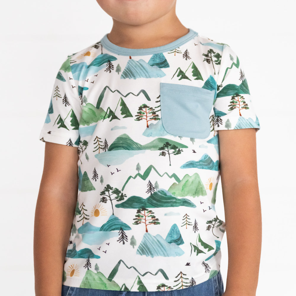 Close up image of a child wearing a Mountain Mist Pocket Tee