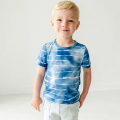 Child wearing a Blue Tie Dye Dreams classic tee with coordinating Play bottoms