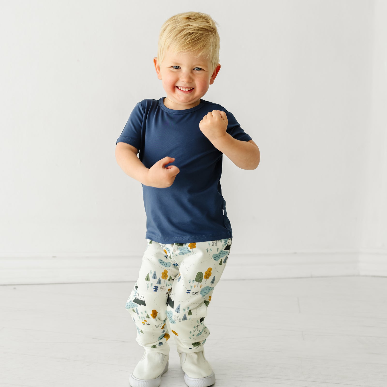 Child jumping, wearing a Vintage Navy classic tee and coordinating Play jogger